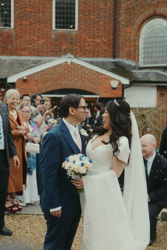 Straight after the confetti bubble walk the couple are all smiles. This photo was captured as part of the couples wedding content creation package. 