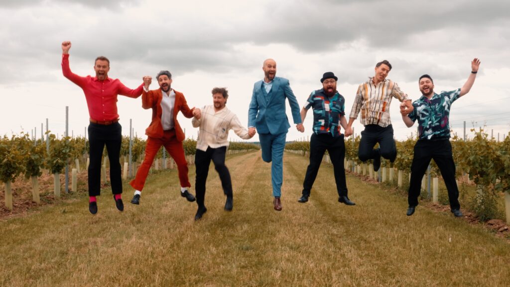 Cool groom and his groomsmen jump for joy on his wedding day. Captured by Cool wedding videographer HC Visuals.
