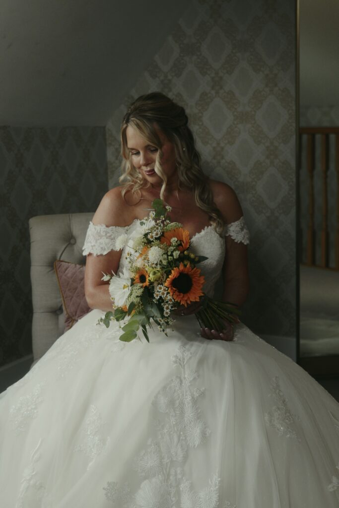 A bride captured on the morning of her wedding day by Wedding Videographer and Photographer HC Visuals. In this blog post HC Visuals breaks down how much it costs to have a wedding videographer. 