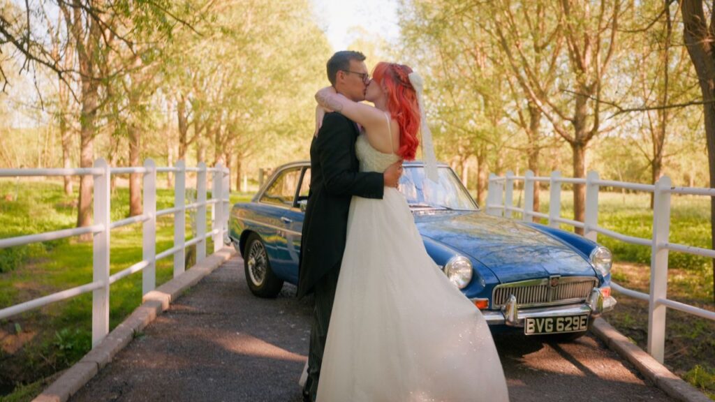 A couple embrace on their wedding day, luckily there was a wedding videographer there to capture all of the amazing moments. 